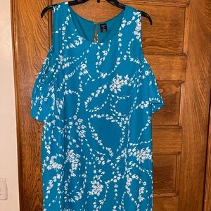 A beautiful teal color dress that comes below the knee.